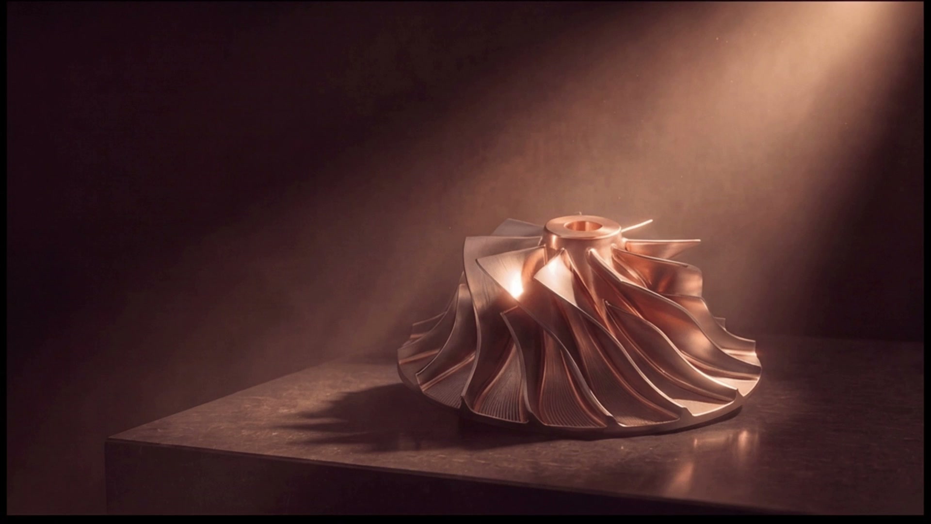A precision-machined copper turbine impeller under a single shaft of light.